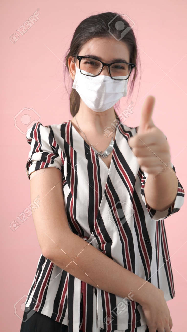 Young woman showing COVID-19 vaccine bandage merrily in concept of coronavirus vaccination program to vaccinate citizen . - 171905636 Young woman showing COVID-19 vaccine bandage merrily in concept of coronavirus vaccination program to vaccinate citizen . - 171905636