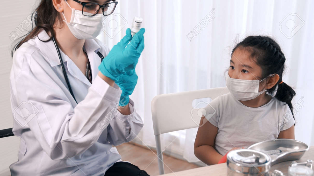 School girl visits skillful doctor at hospital for vaccination . Covid 19 and coronavirus vaccination center service concept . - 171940817 School girl visits skillful doctor at hospital for vaccination . Covid 19 and coronavirus vaccination center service concept . - 171940817