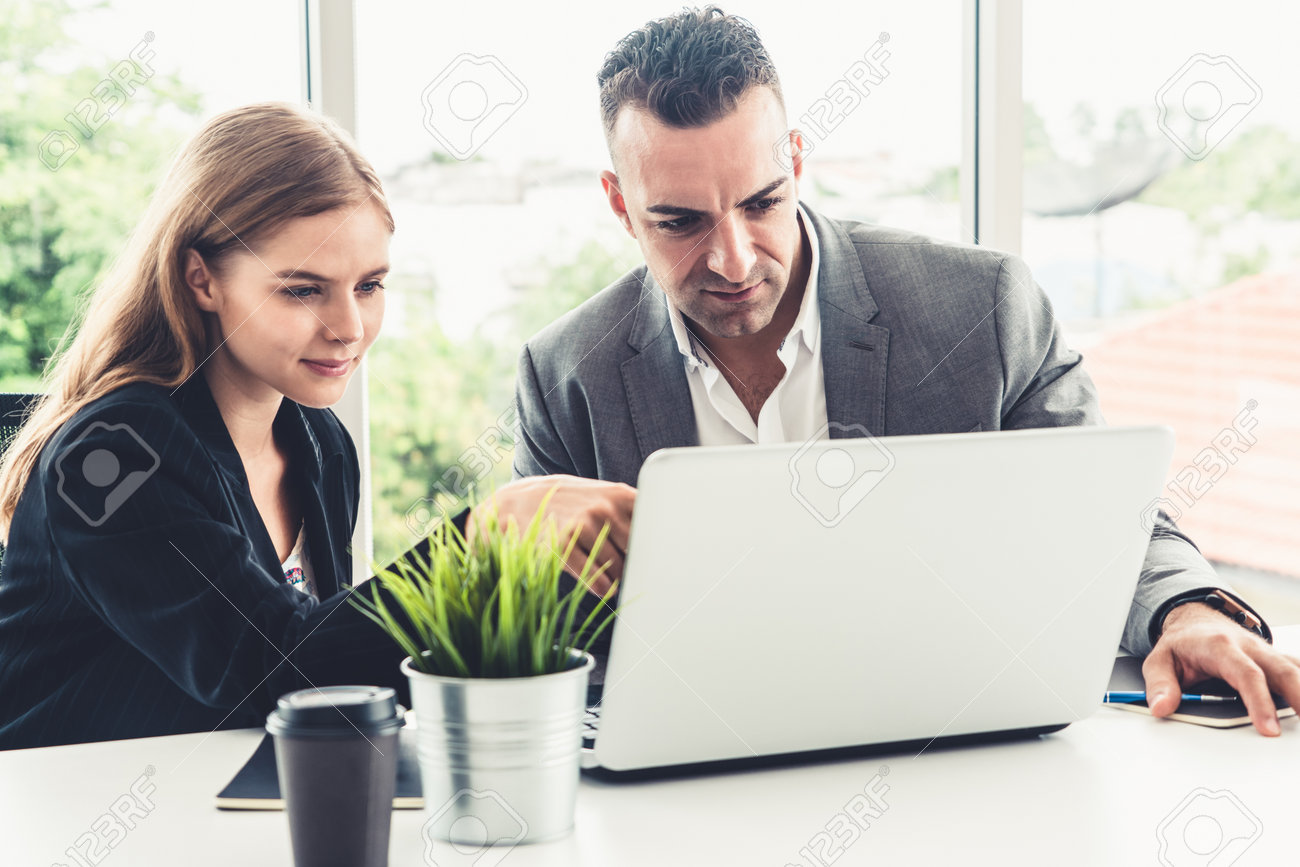 Businessman executive is in meeting discussion with a businesswoman worker in modern workplace office. People corporate business team concept. - 171925676 Businessman executive is in meeting discussion with a businesswoman worker in modern workplace office. People corporate business team concept. - 171925676