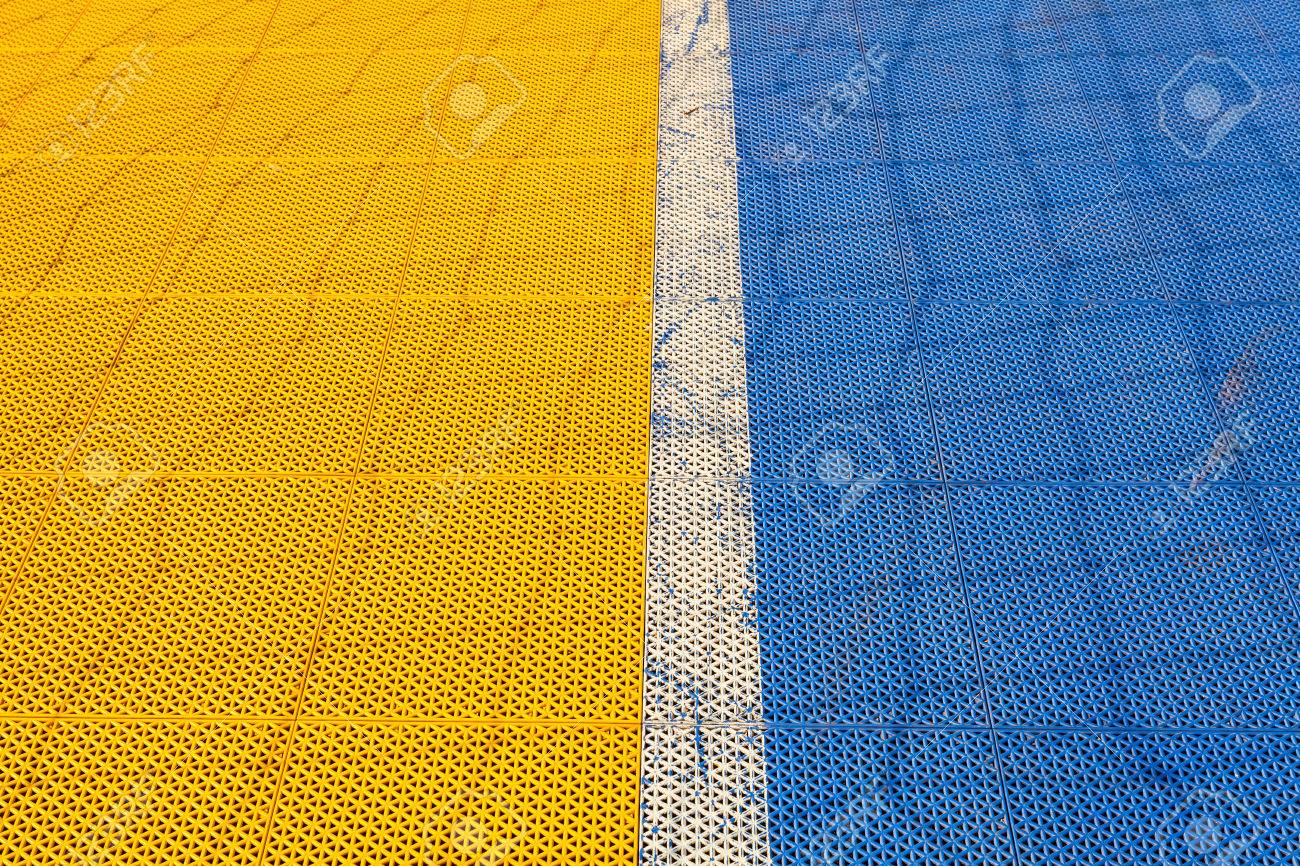 Blue And Yellow Rubber Flooring On Futsal Field Background Stock Photo Blue And Yellow Rubber Flooring On Futsal Field Background Stock Photo