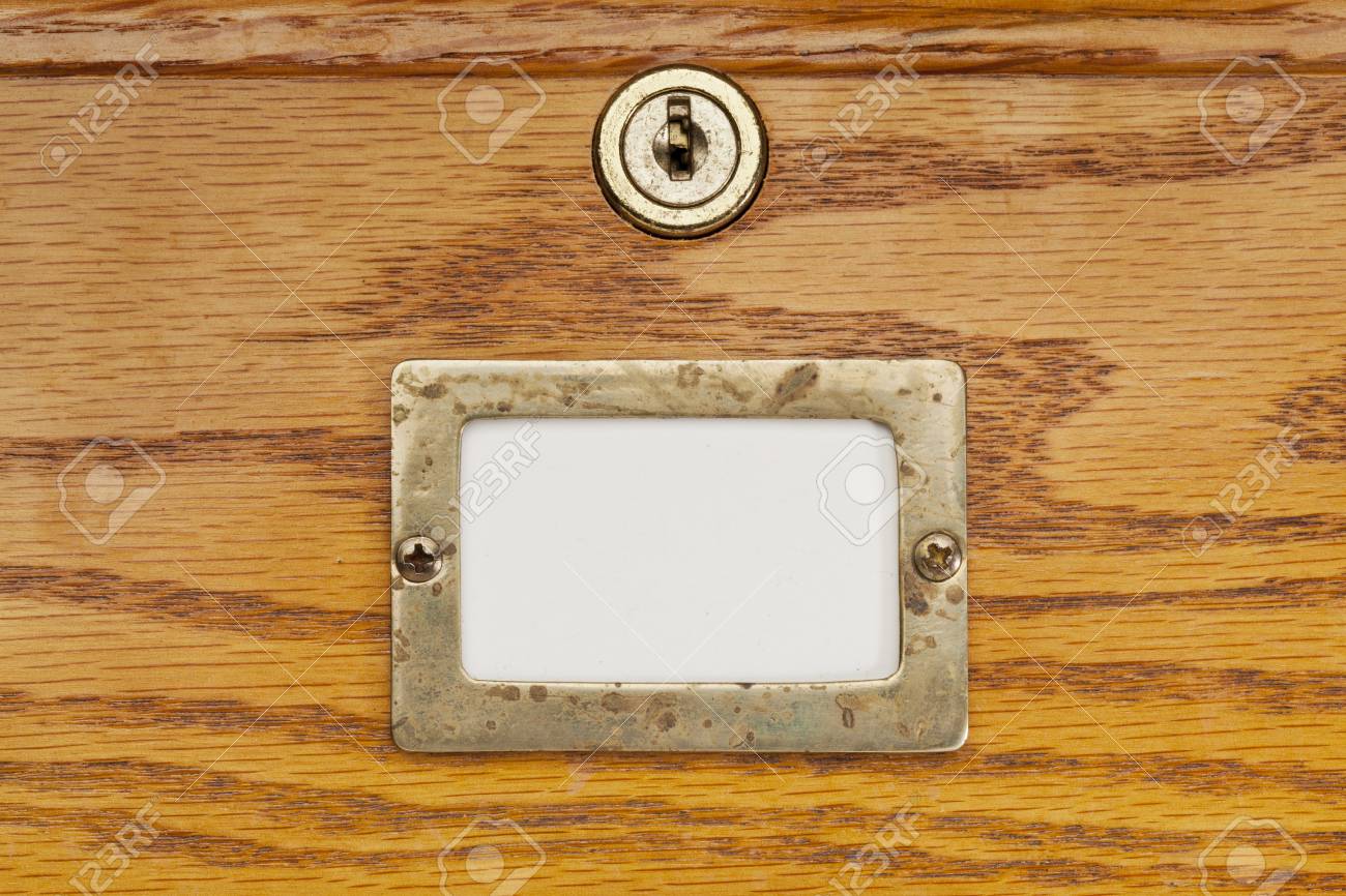 Blank Label In Brass Holder On A Wooden File Cabinet Drawer With