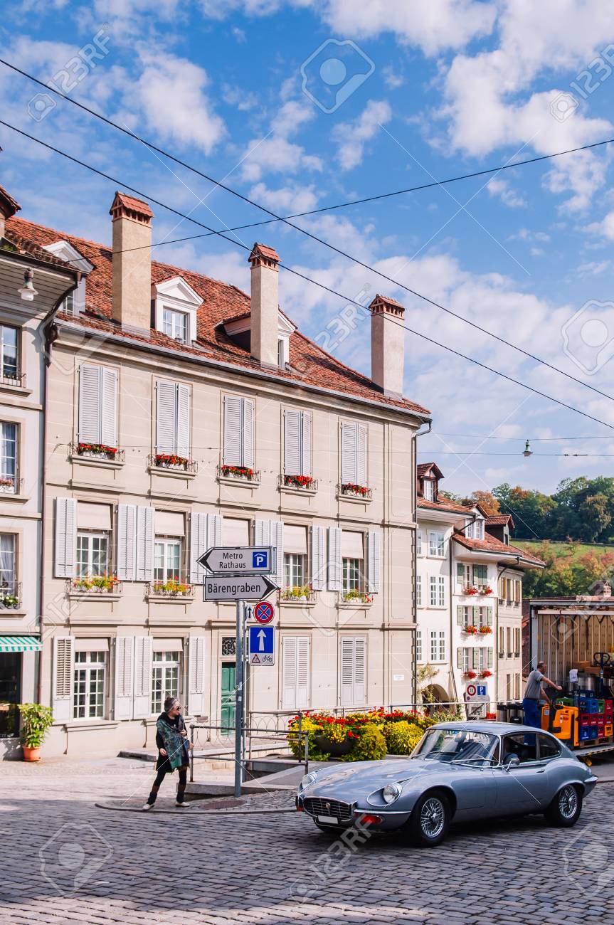 Sep 27 2103 Bern Switzerland Luxury Vintage Sport Car On Nydaggasse Street Swiss Residential Building With Flower Pot Window And Street Sign In Old Town District Of Bern Stock Photo Picture