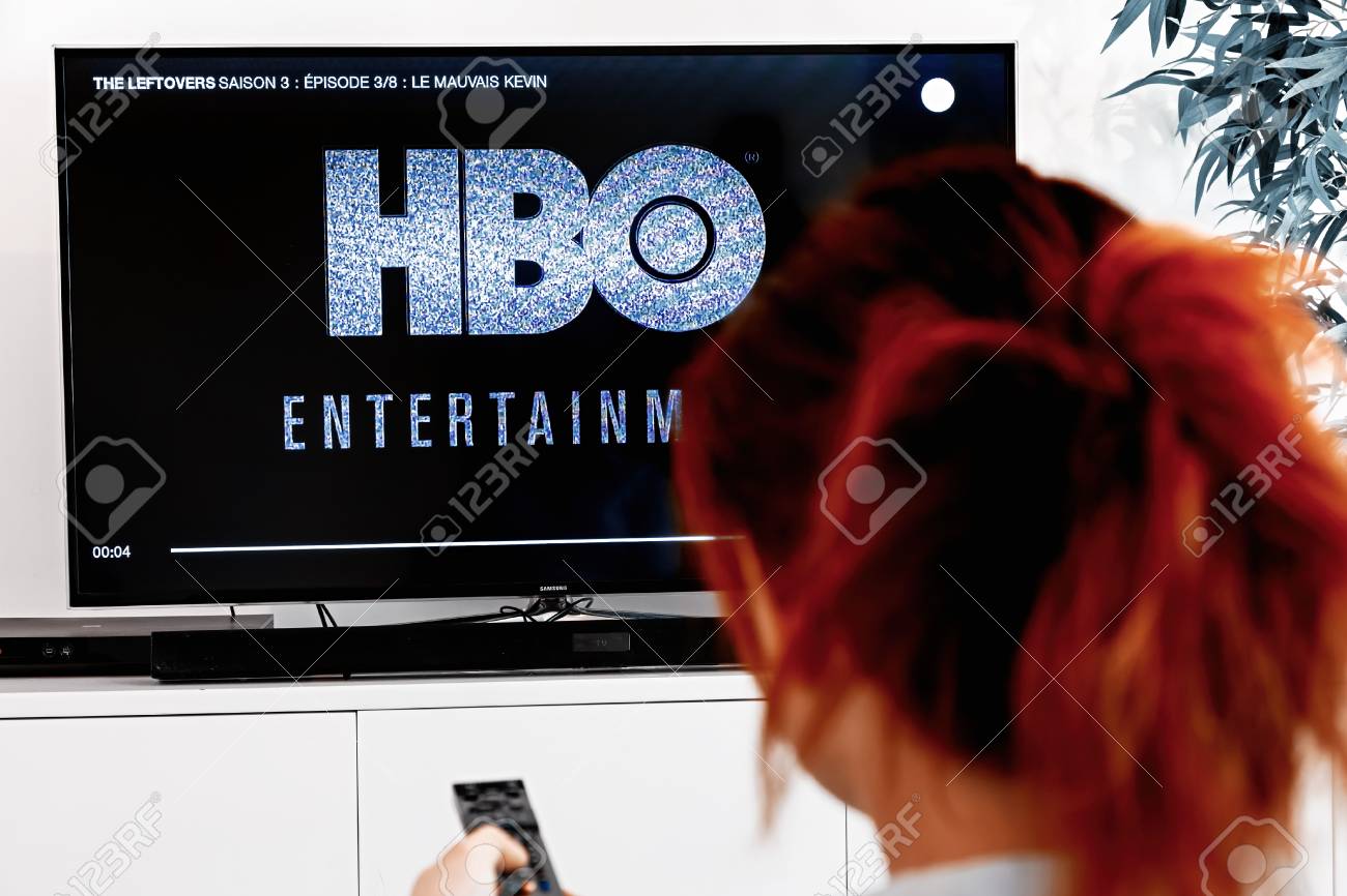 Benon, France - December 30, 2018: Woman watching tv serie produced by HBO which we see logo at the show begening. HBO is an American multinational entertainment company part of the WarnerMedia group - 115125609 Benon, France - December 30, 2018: Woman watching tv serie produced by HBO which we see logo at the show begening. HBO is an American multinational entertainment company part of the WarnerMedia group - 115125609