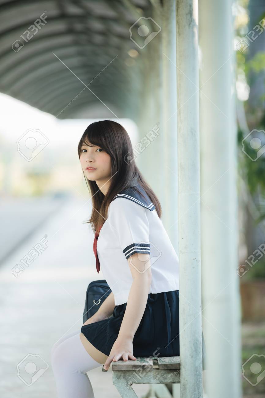 Portrait Of Asian Japanese School Girl Costume Sitting And Looking At Park  Outdoor Stock Photo, Picture and Royalty Free Image. Image 124616152.