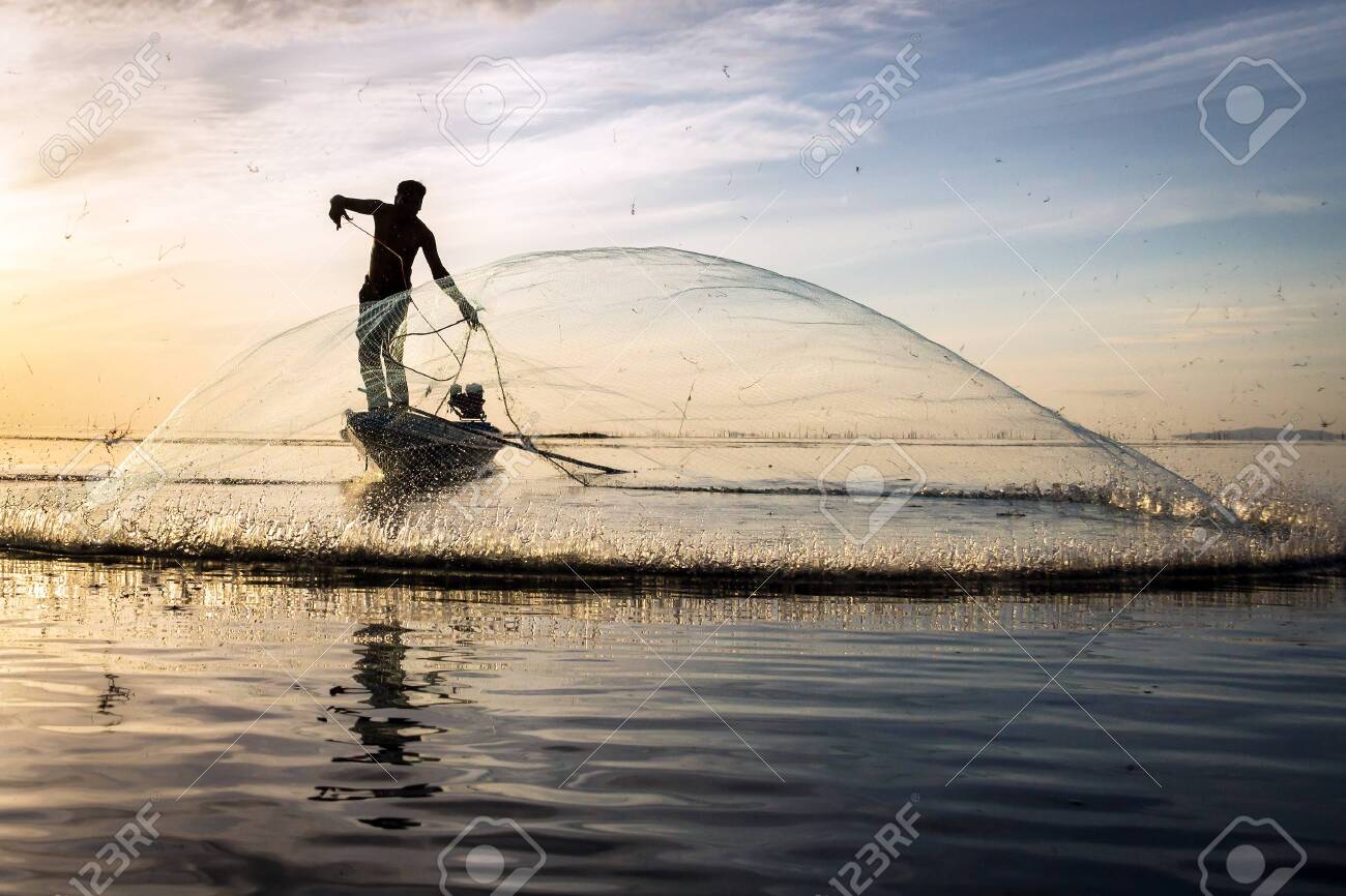 Silhouette Of Traditional Fishermen Throwing Net Fishing At Sunrise Stock Photo Picture And Royalty Free Image Image 128365638