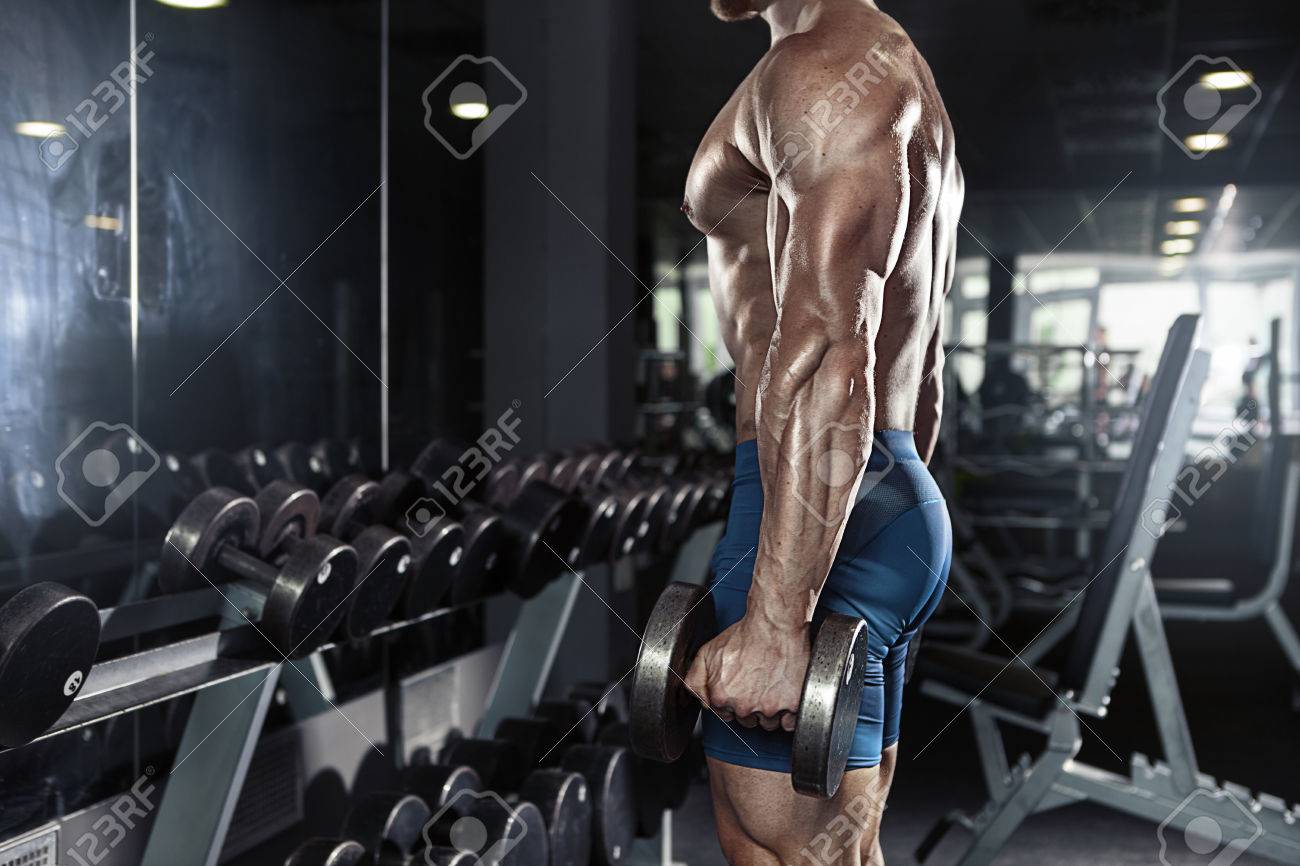 Muscular bodybuilder guy doing exercises with big dumbbell in gym - 41521334 Muscular bodybuilder guy doing exercises with big dumbbell in gym - 41521334
