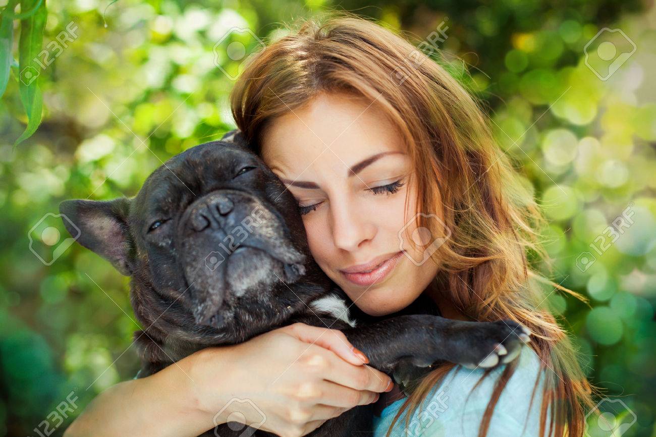 Happy woman with french bulldog on blurred nature background - 41847144 Happy woman with french bulldog on blurred nature background - 41847144