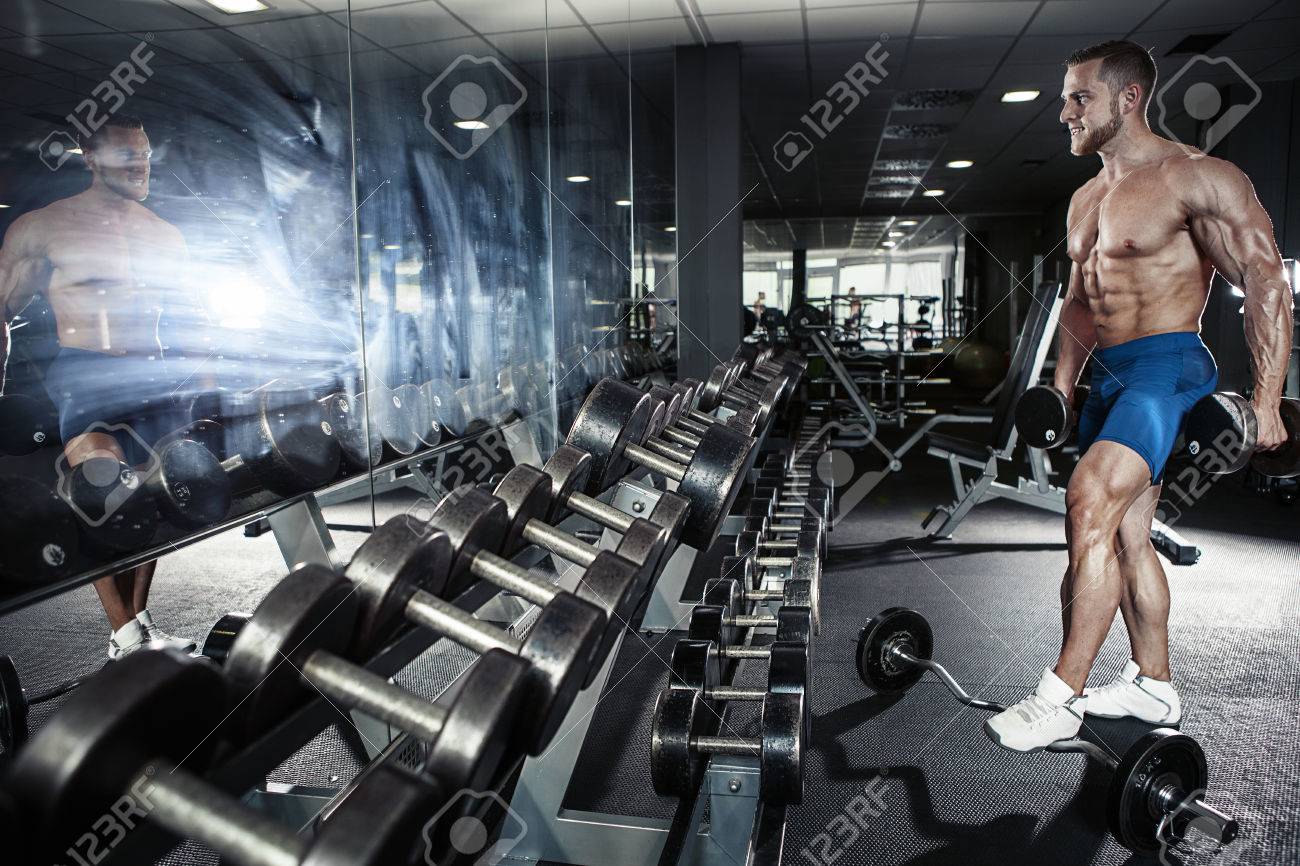 Muscular bodybuilder guy doing exercises with dumbbell in gym - 41847210 Muscular bodybuilder guy doing exercises with dumbbell in gym - 41847210