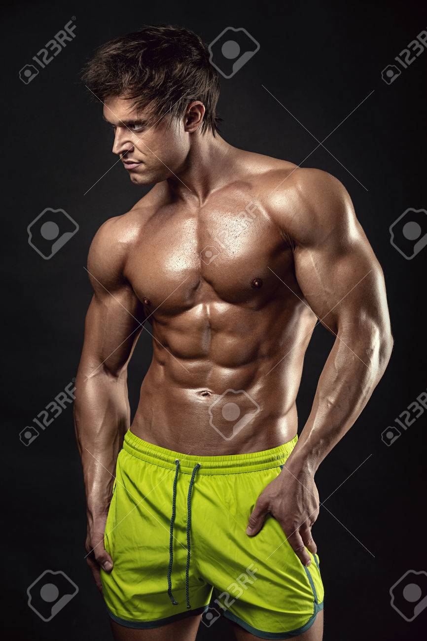 Strong Athletic Man Fitness Model Torso showing big muscles over black background - 53597512 Strong Athletic Man Fitness Model Torso showing big muscles over black background - 53597512