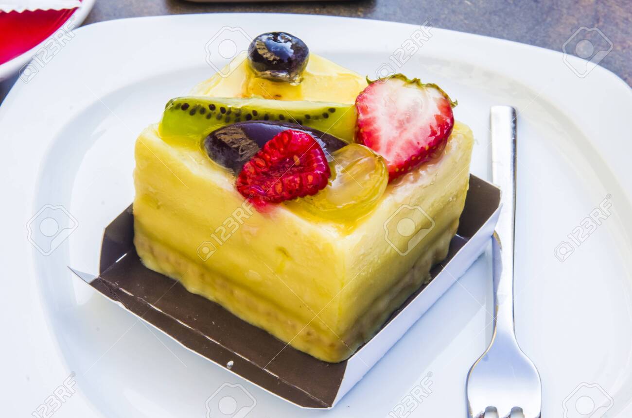 cake, passion fruit semifreddo cube with strawberry, kiwi, grapes, plum, blackberry and cape gooseberries - 147457341 cake, passion fruit semifreddo cube with strawberry, kiwi, grapes, plum, blackberry and cape gooseberries - 147457341