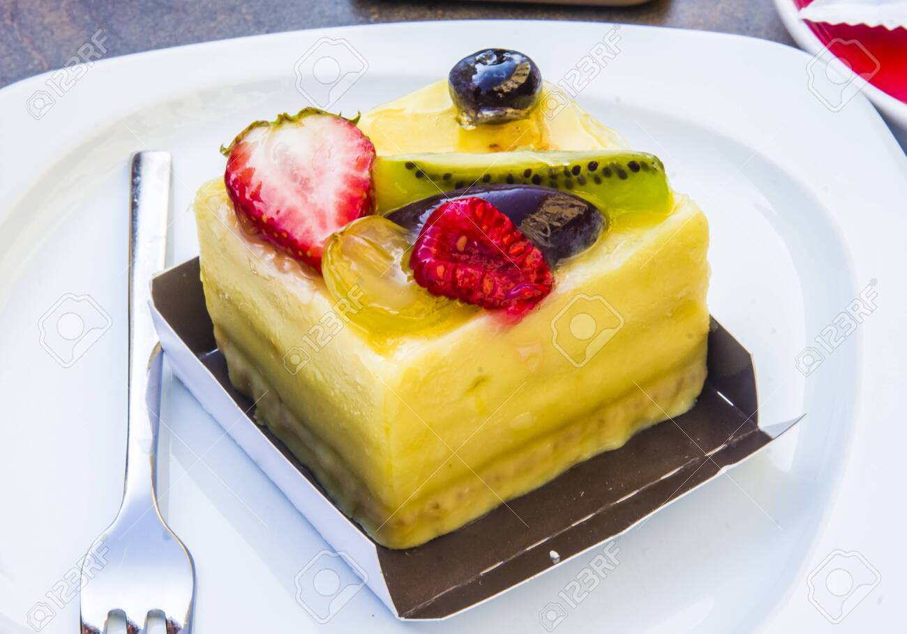 cake, passion fruit semifreddo cube with strawberry, kiwi, grapes, plum, blackberry and cape gooseberries - 147457342 cake, passion fruit semifreddo cube with strawberry, kiwi, grapes, plum, blackberry and cape gooseberries - 147457342