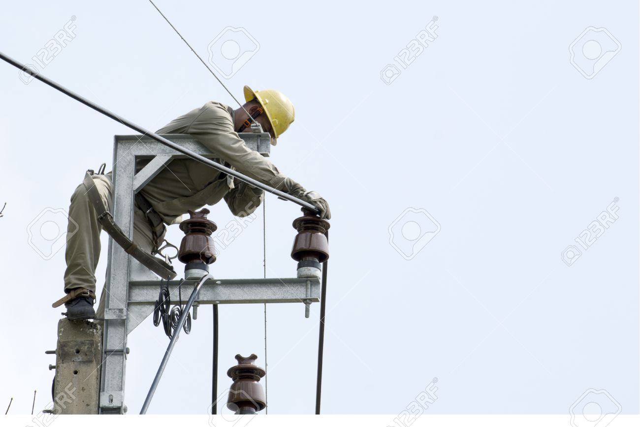 one electrician lineman at climbing work on electrical post power
