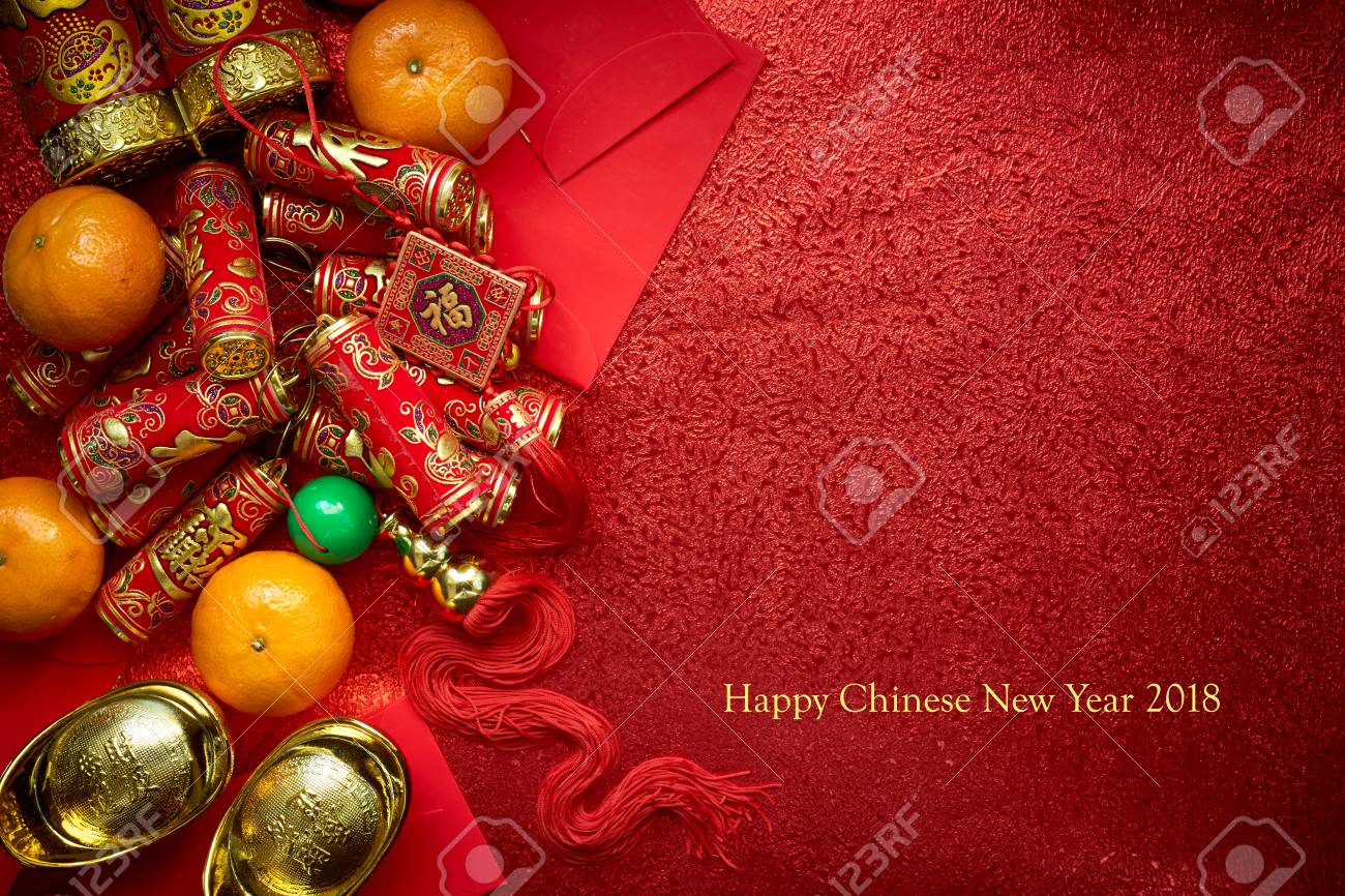 Chinese coins or Chinese knot of luck and chinese firecrackers and Chinese gold ingots and Traditional chinese knot (Foreign text means blessing) and Red envelopes and decoration with Fresh oranges on Red Paper background - 90279932 Chinese coins or Chinese knot of luck and chinese firecrackers and Chinese gold ingots and Traditional chinese knot (Foreign text means blessing) and Red envelopes and decoration with Fresh oranges on Red Paper background - 90279932