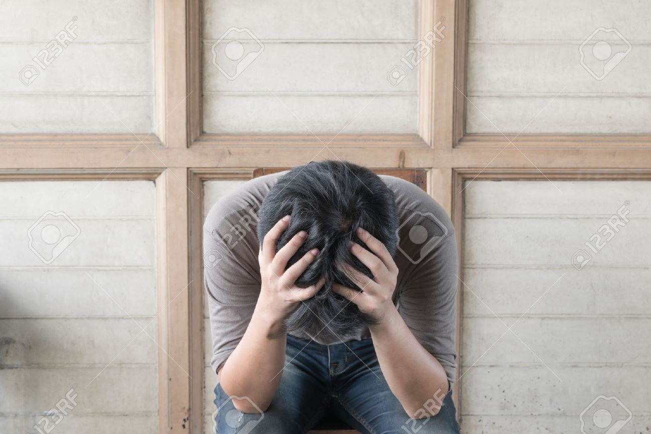 Anxious asian man feeling sadness and stress sitting on the chair - 52511653 Anxious asian man feeling sadness and stress sitting on the chair - 52511653