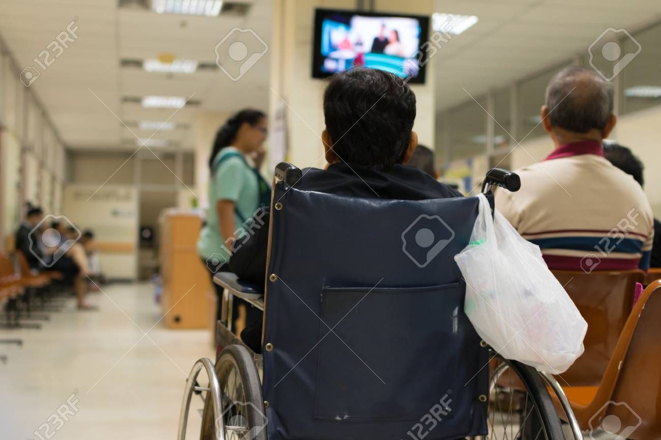 Patient elderly on wheelchair and many patient waiting a doctor and nurse in hospital - 52917867 Patient elderly on wheelchair and many patient waiting a doctor and nurse in hospital - 52917867