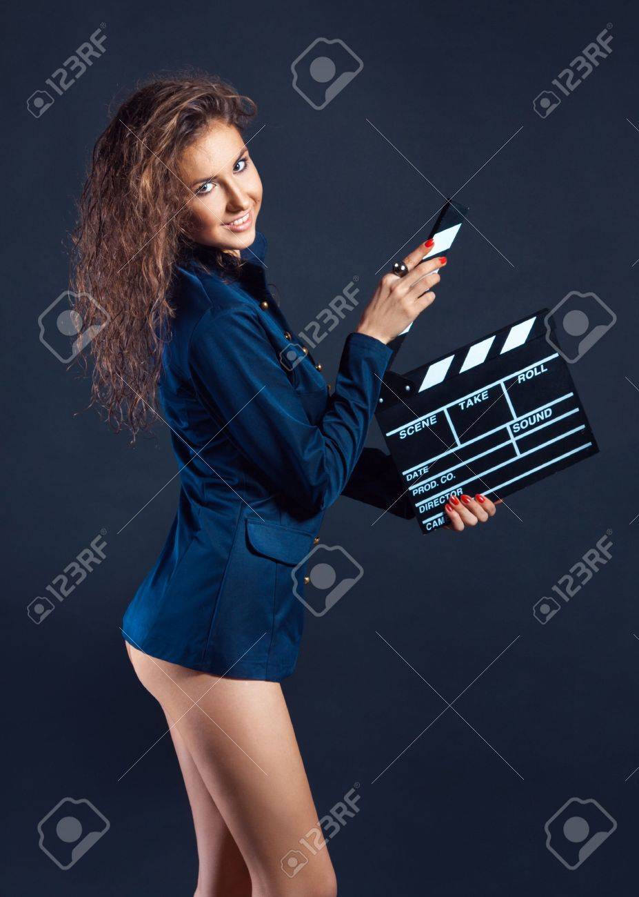 Sexy Young Woman With Film Slate In Studio On Blue Background Stock Photo,  Picture and Royalty Free Image. Image 19353792.