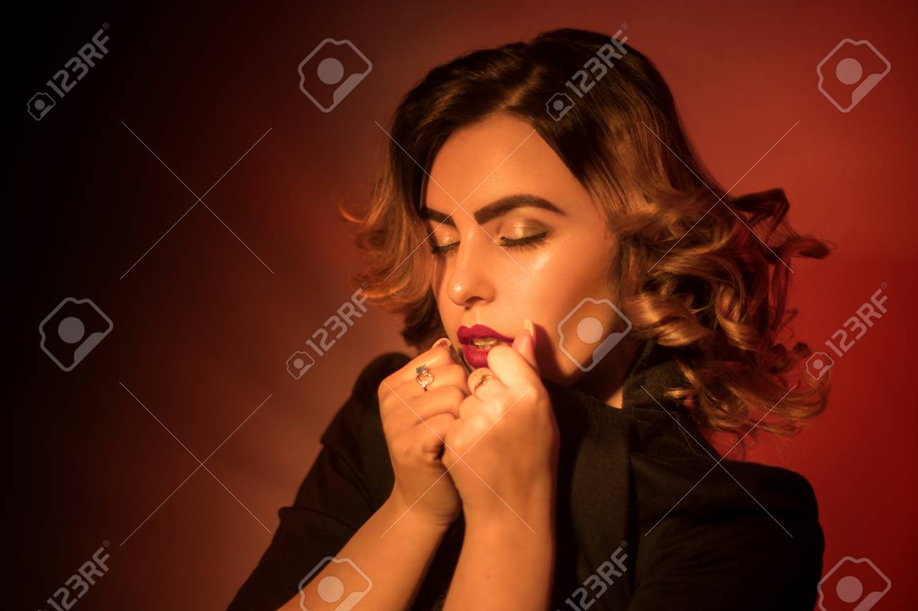 Hot Young Woman With Red Lips And Curly Short Hairstyle In Studio