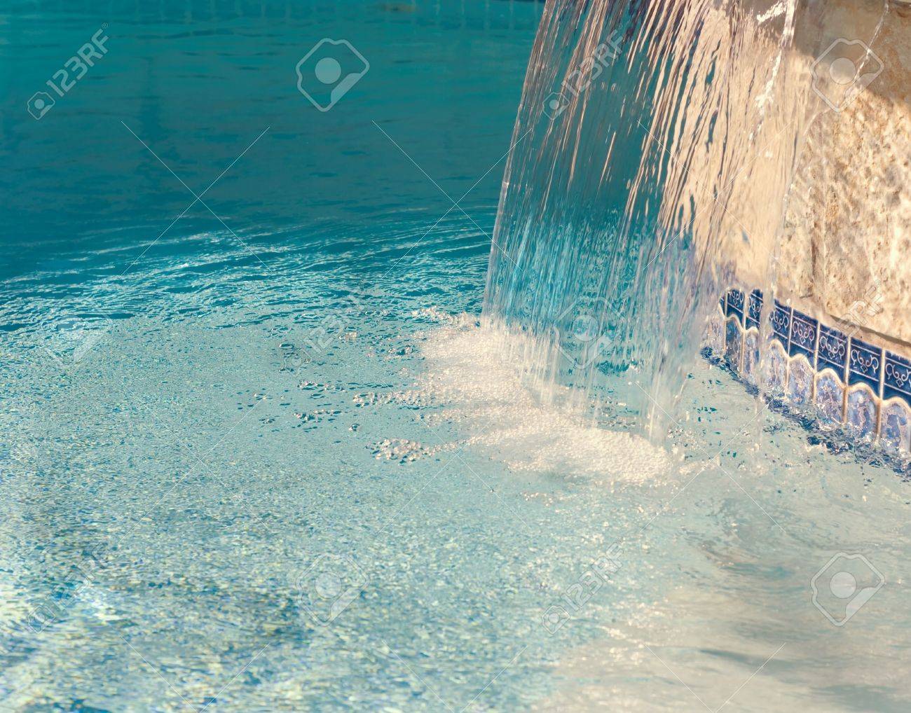 Pool Water Splash cool water splashing down from a hot tub into a pool stock photo Pool Water Splash cool water splashing down from a hot tub into a pool stock photo
