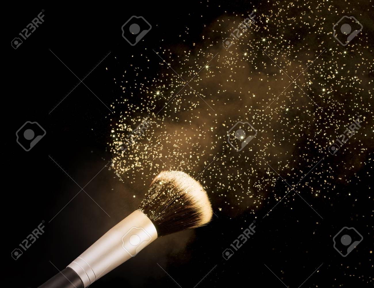 golden glittering blusher explosion isolated on black background - 73420454 golden glittering blusher explosion isolated on black background - 73420454