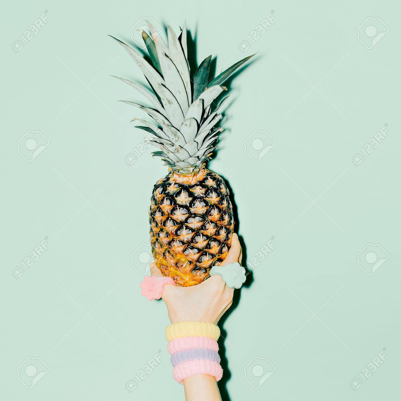 Fashion photo. Hand holding pineapple. vanilla style - 37664407 Fashion photo. Hand holding pineapple. vanilla style - 37664407