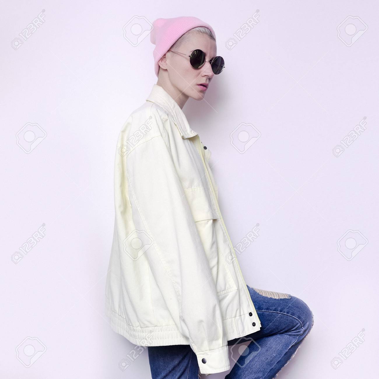 tomboy girl in hipster hat beanie and vintage sports jacket jeans
