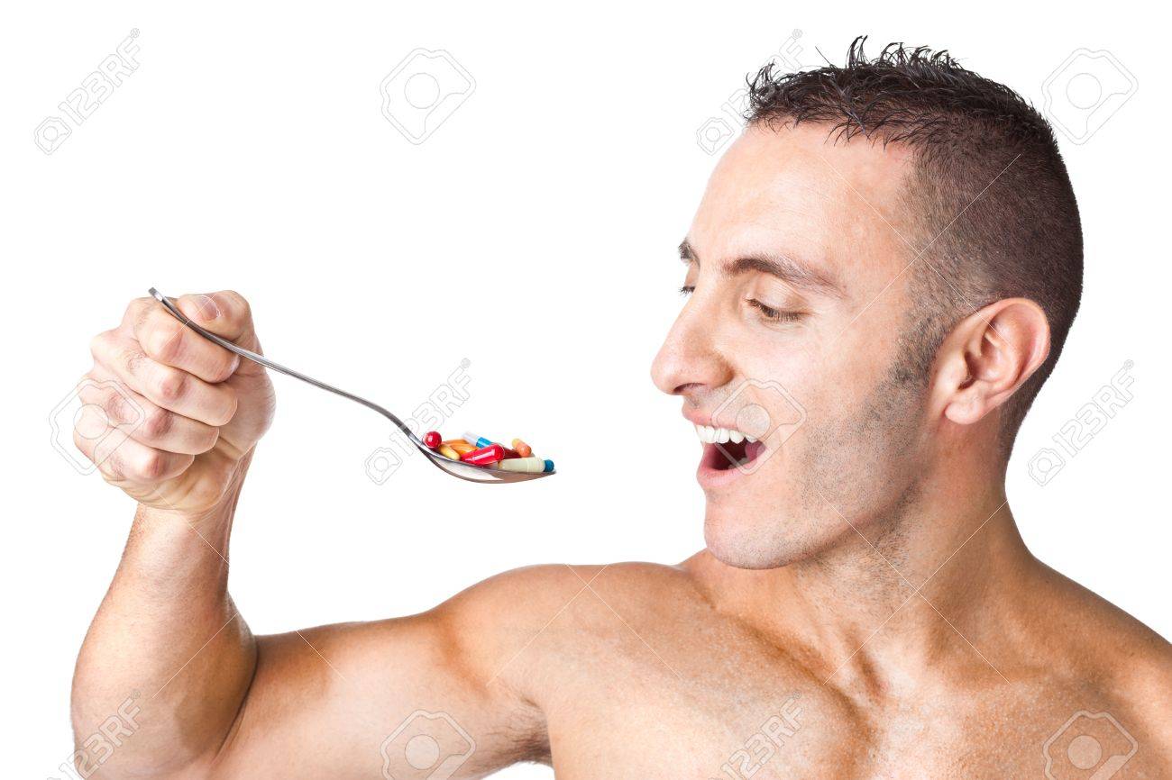 Ein Stattlicher Mann Der Einen Loffel Voll Von Pillen Lizenzfreie Fotos Bilder Und Stock Fotografie Image 19589512