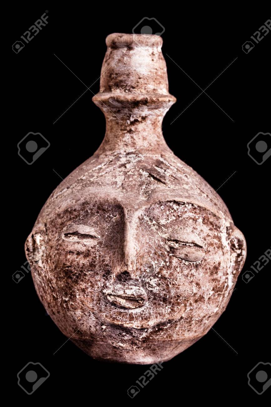 An Ancient Terracotta Vase Or Jug Shaped Like A Human Face
