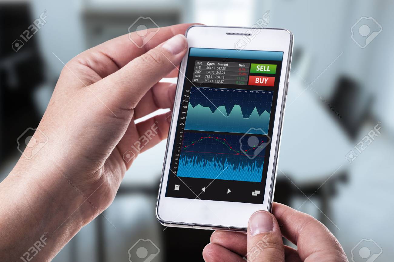 A Woman Holding A Smart Phone Running A Trading Or Forex App - 