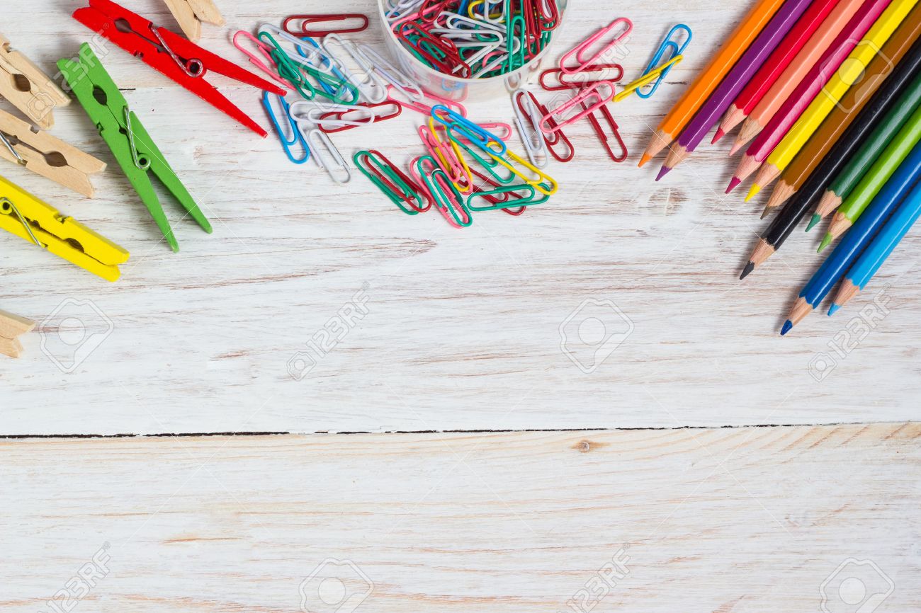 Desk of an artist, colorful pencils and paperclips on the white wooden table background - 44250378 Desk of an artist, colorful pencils and paperclips on the white wooden table background - 44250378