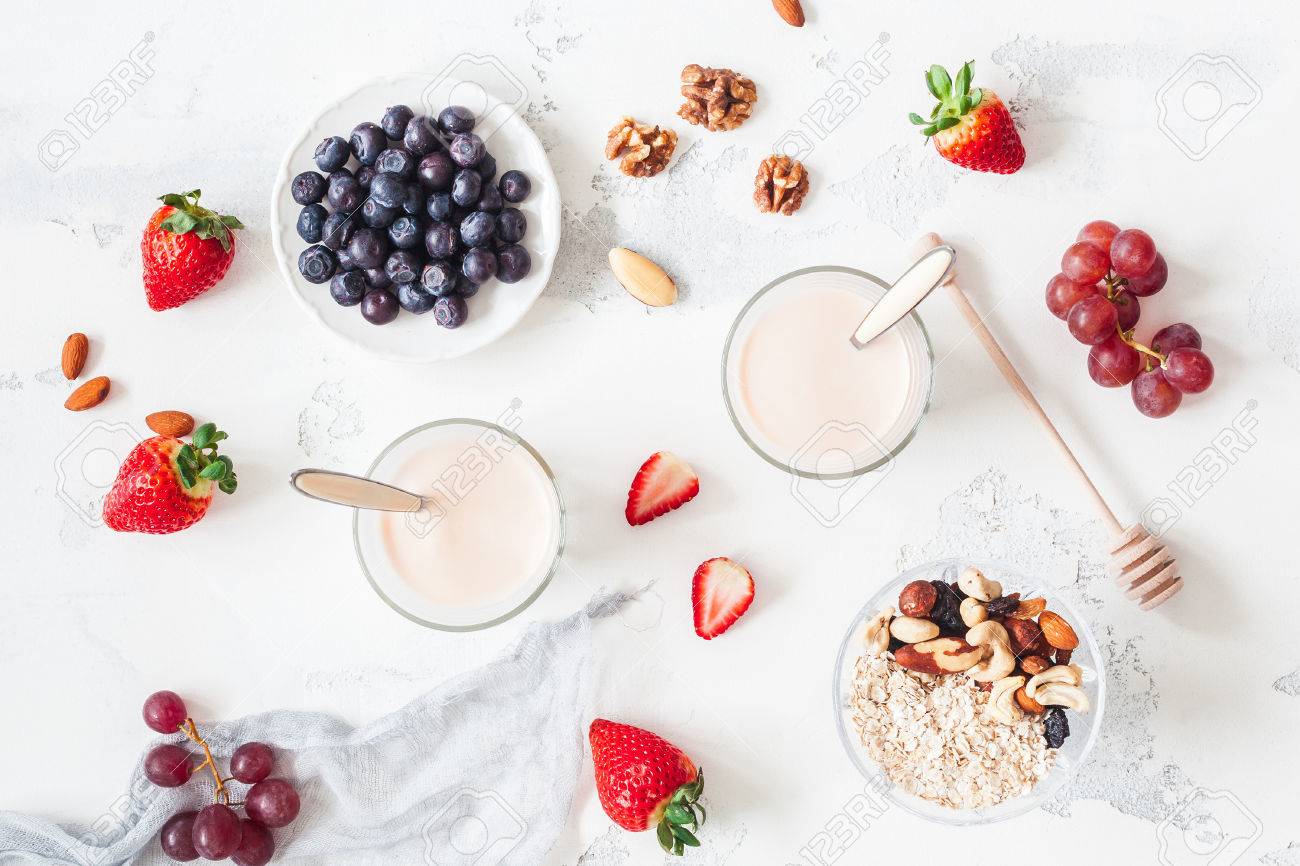 Breakfast with muesli, yogurt, strawberry, blueberry, nuts on white background. Healthy food concept. Flat lay, top view - 81119717 Breakfast with muesli, yogurt, strawberry, blueberry, nuts on white background. Healthy food concept. Flat lay, top view - 81119717