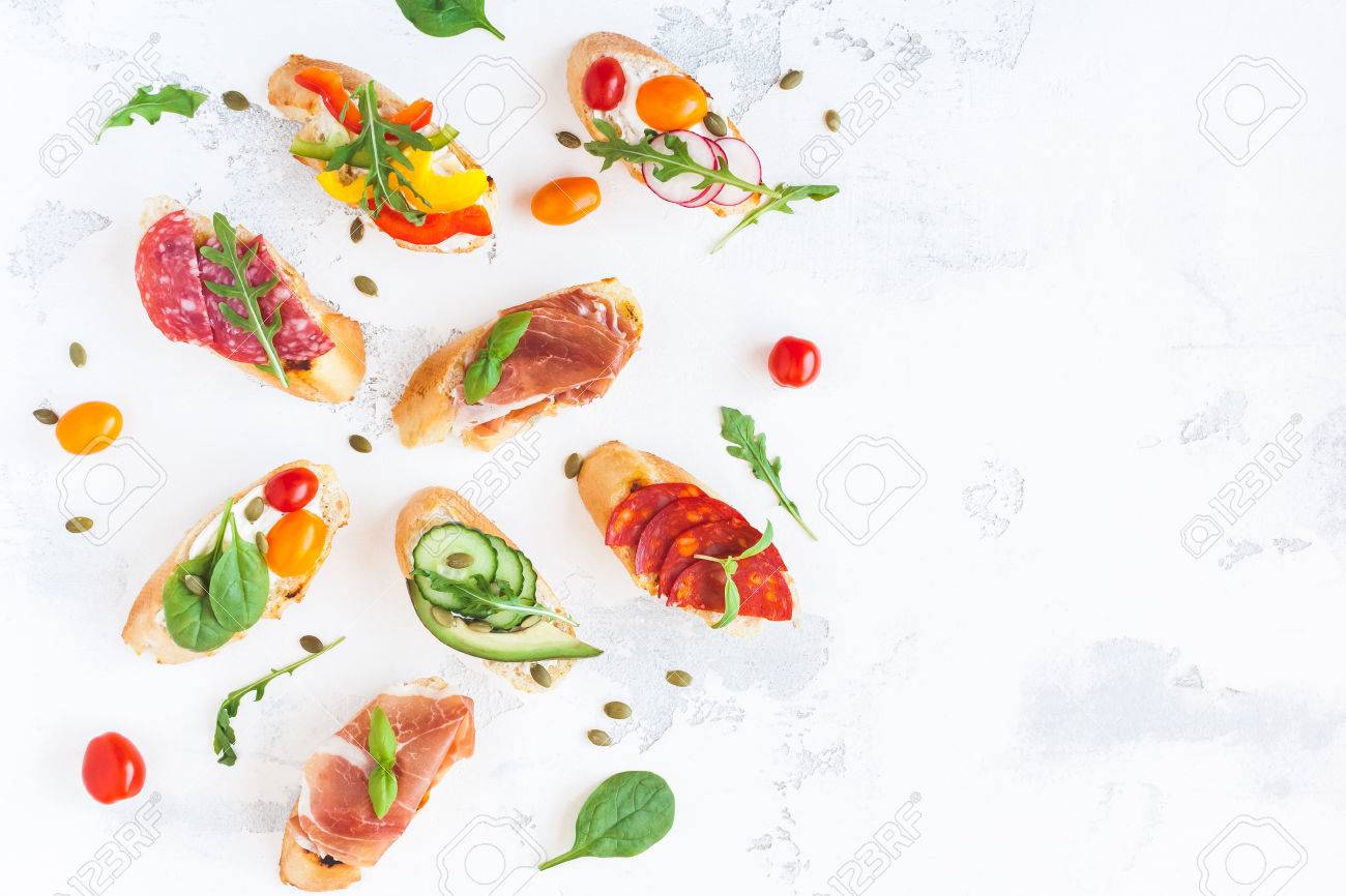 Traditional spanish tapas on white table. Brushetta set. Flat lay, top view, copy space - 83485613 Traditional spanish tapas on white table. Brushetta set. Flat lay, top view, copy space - 83485613