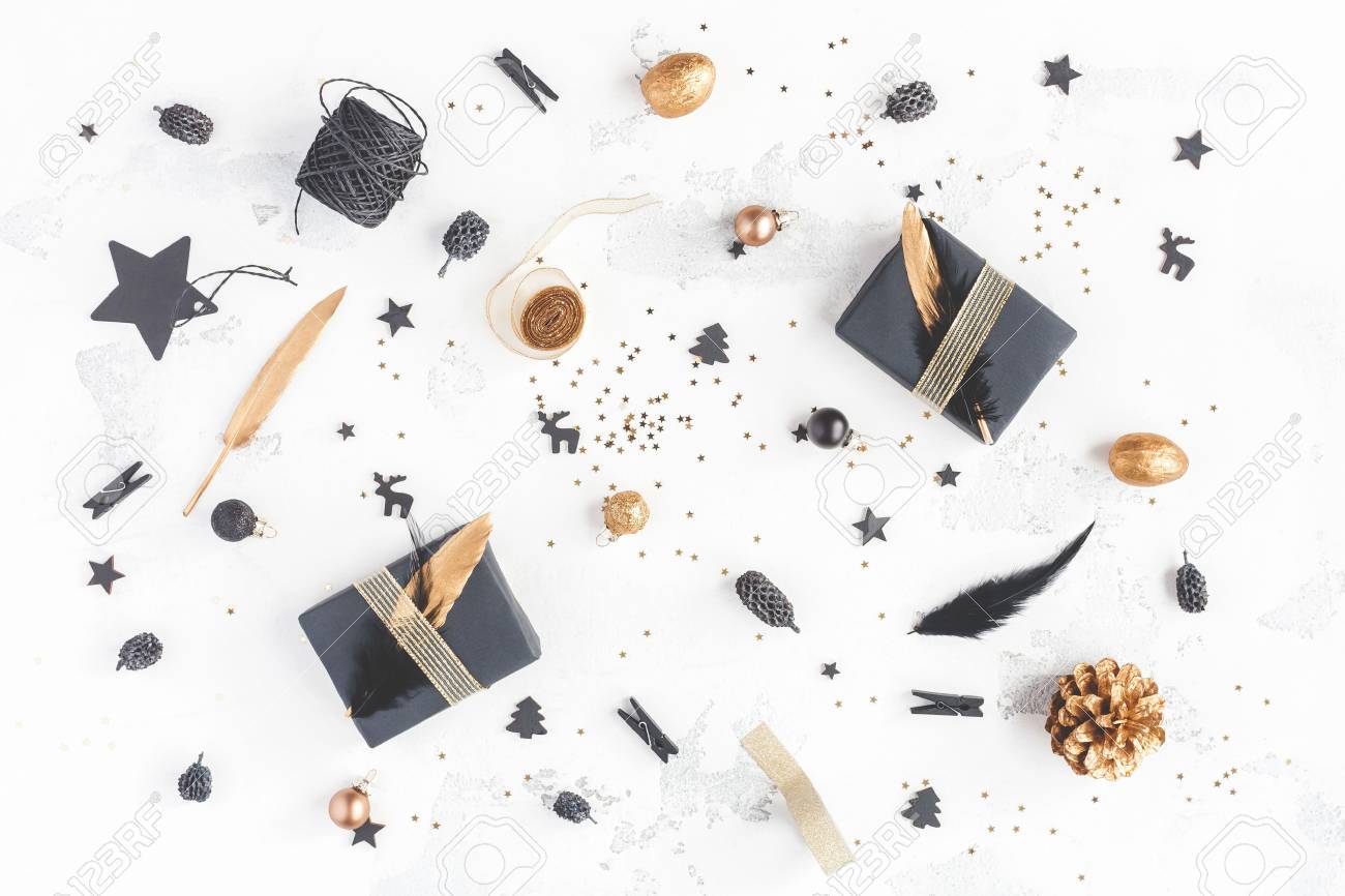 Christmas composition. Christmas gifts, pine cones, black and golden decorations on white background. Flat lay, top view - 87071270 Christmas composition. Christmas gifts, pine cones, black and golden decorations on white background. Flat lay, top view - 87071270