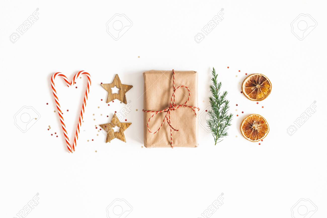 Christmas composition. Gift box, fir tree branches, golden decorations on white background. Christmas, winter, new year concept. Flat lay, top view - 131538168 Christmas composition. Gift box, fir tree branches, golden decorations on white background. Christmas, winter, new year concept. Flat lay, top view - 131538168