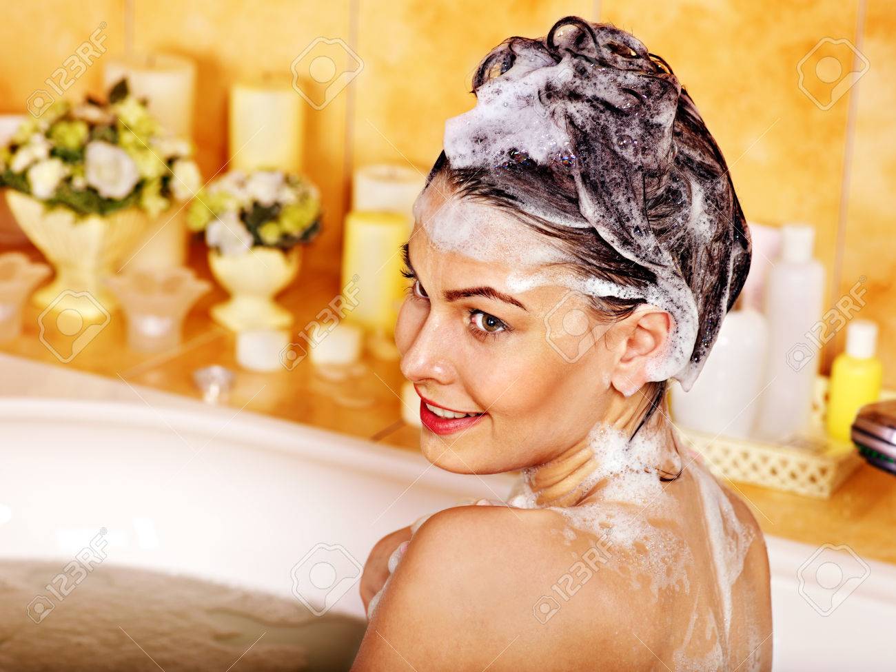 Woman washing hair in bubble bath. - 22673276 Woman washing hair in bubble bath. - 22673276