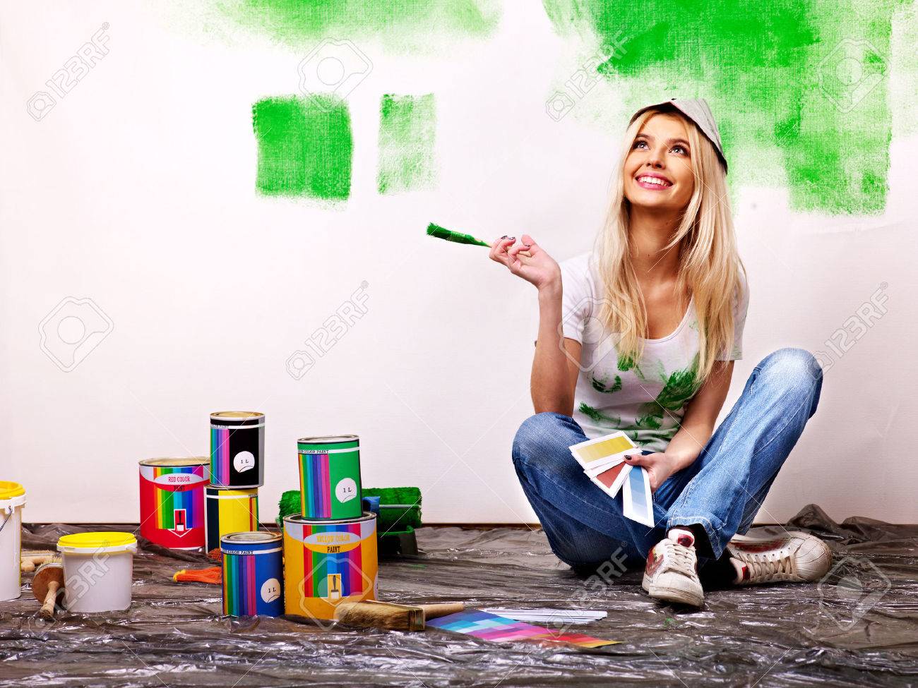 Happy woman paint wall at home. - 23856427 Happy woman paint wall at home. - 23856427