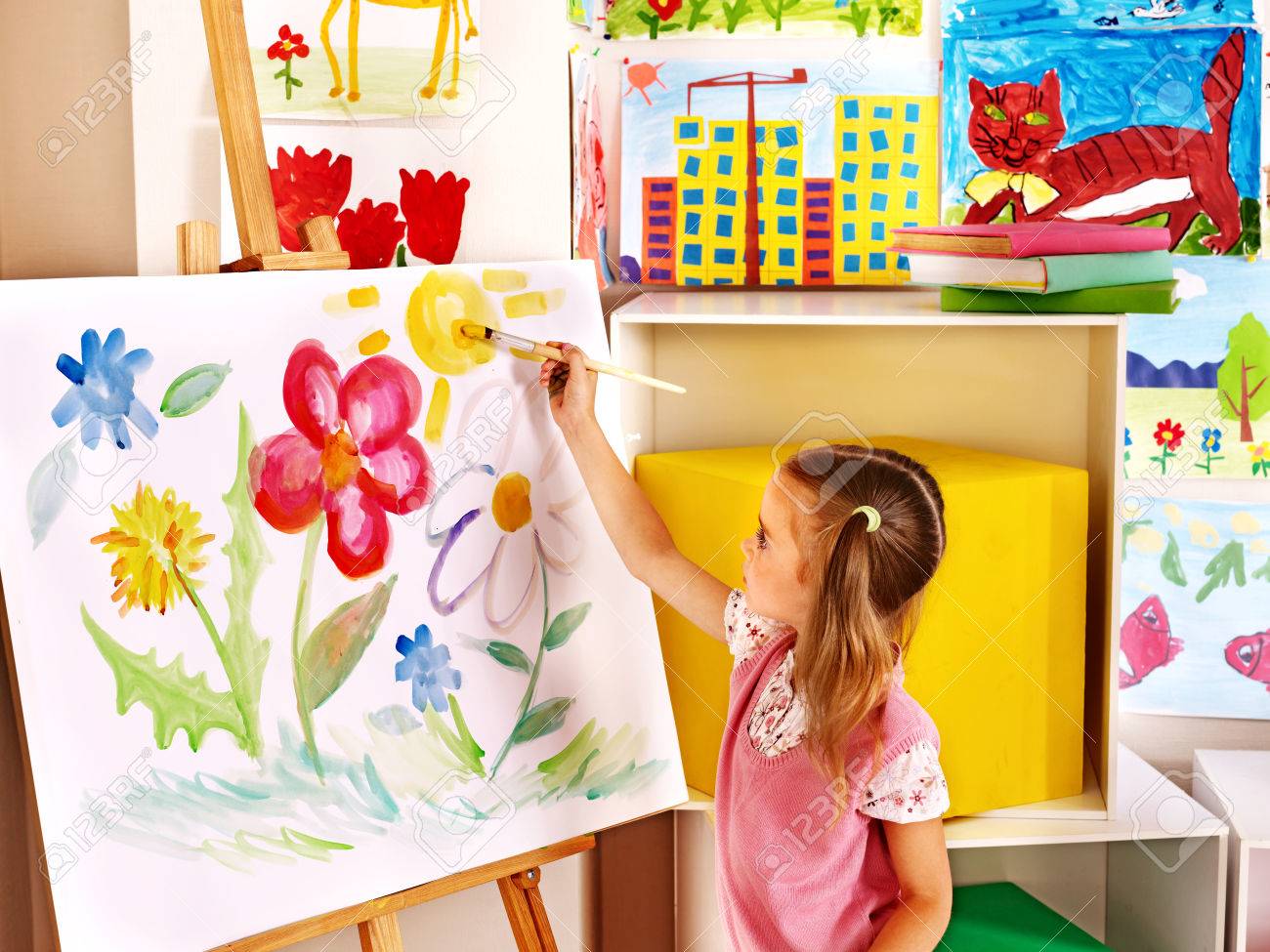 Child painting at easel in art class - 25499215 Child painting at easel in art class - 25499215