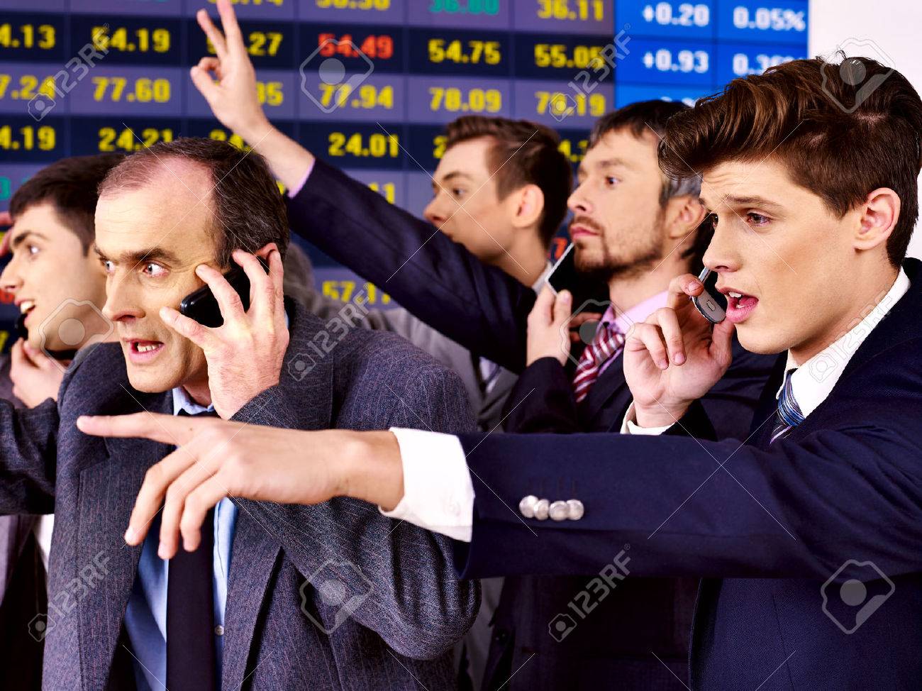 Group business people with stock exchange board in office. - 25573220 Group business people with stock exchange board in office. - 25573220