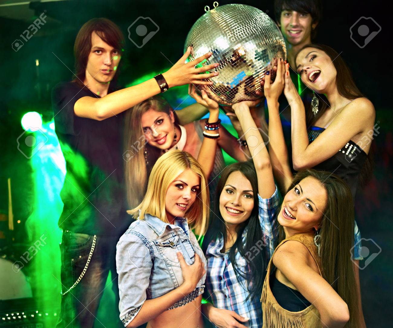 group people on disco in night club lighting effects stock photo