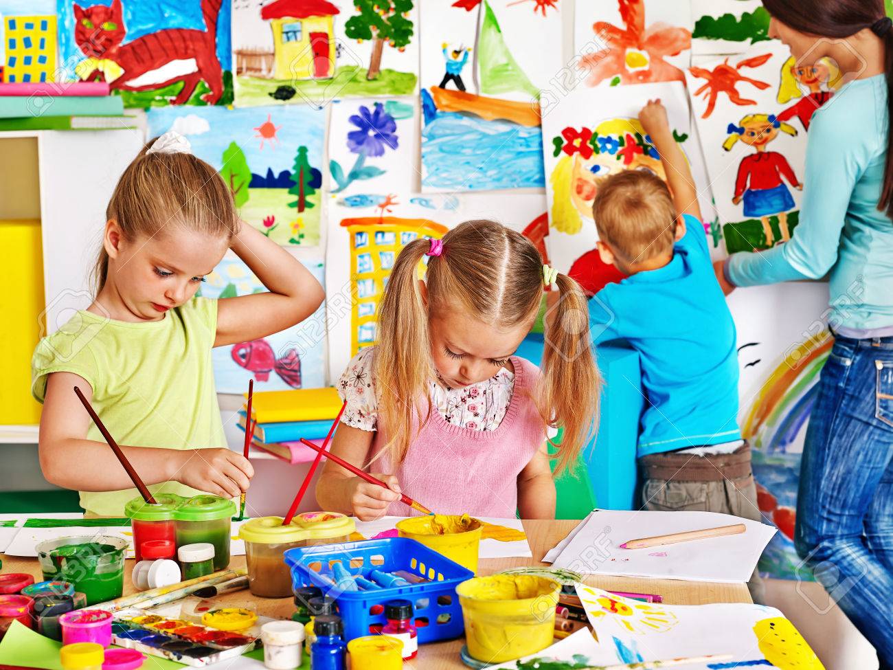 Happy children with teacher painting. - 30839467 Happy children with teacher painting. - 30839467