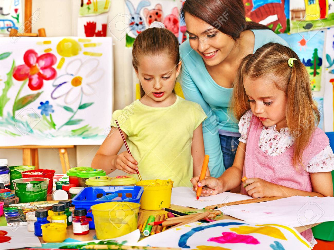 Happy children with teacher painting. - 31450374 Happy children with teacher painting. - 31450374