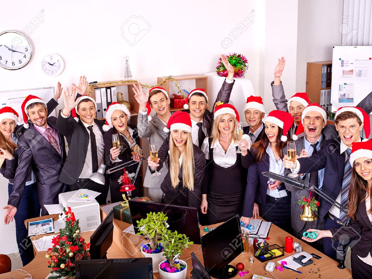 Happy group people in santa hat at Xmas business party. - 34393231 Happy group people in santa hat at Xmas business party. - 34393231