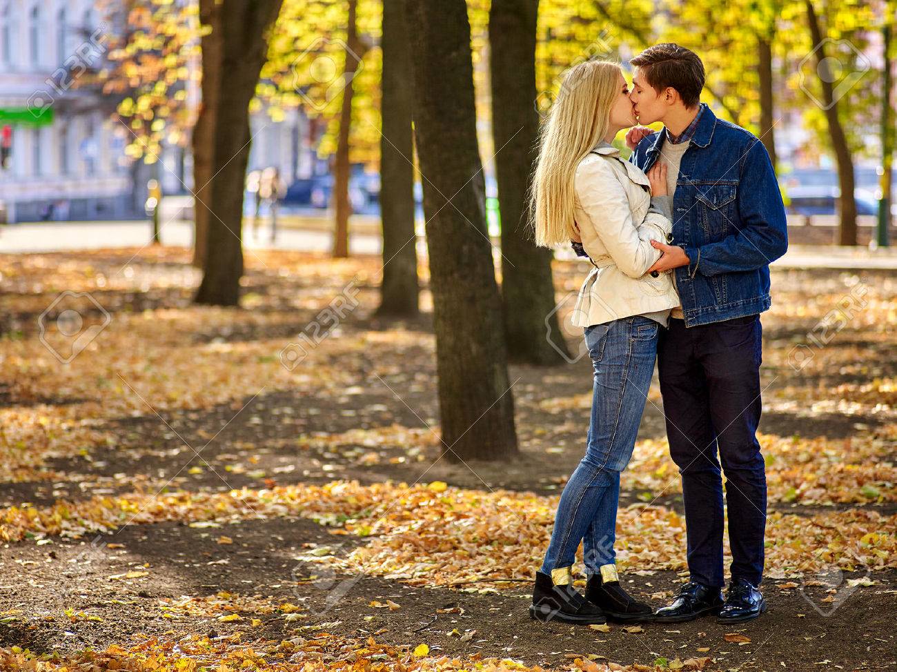 Young couple hugging and flirting in park. Full height. - 47419270 Young couple hugging and flirting in park. Full height. - 47419270