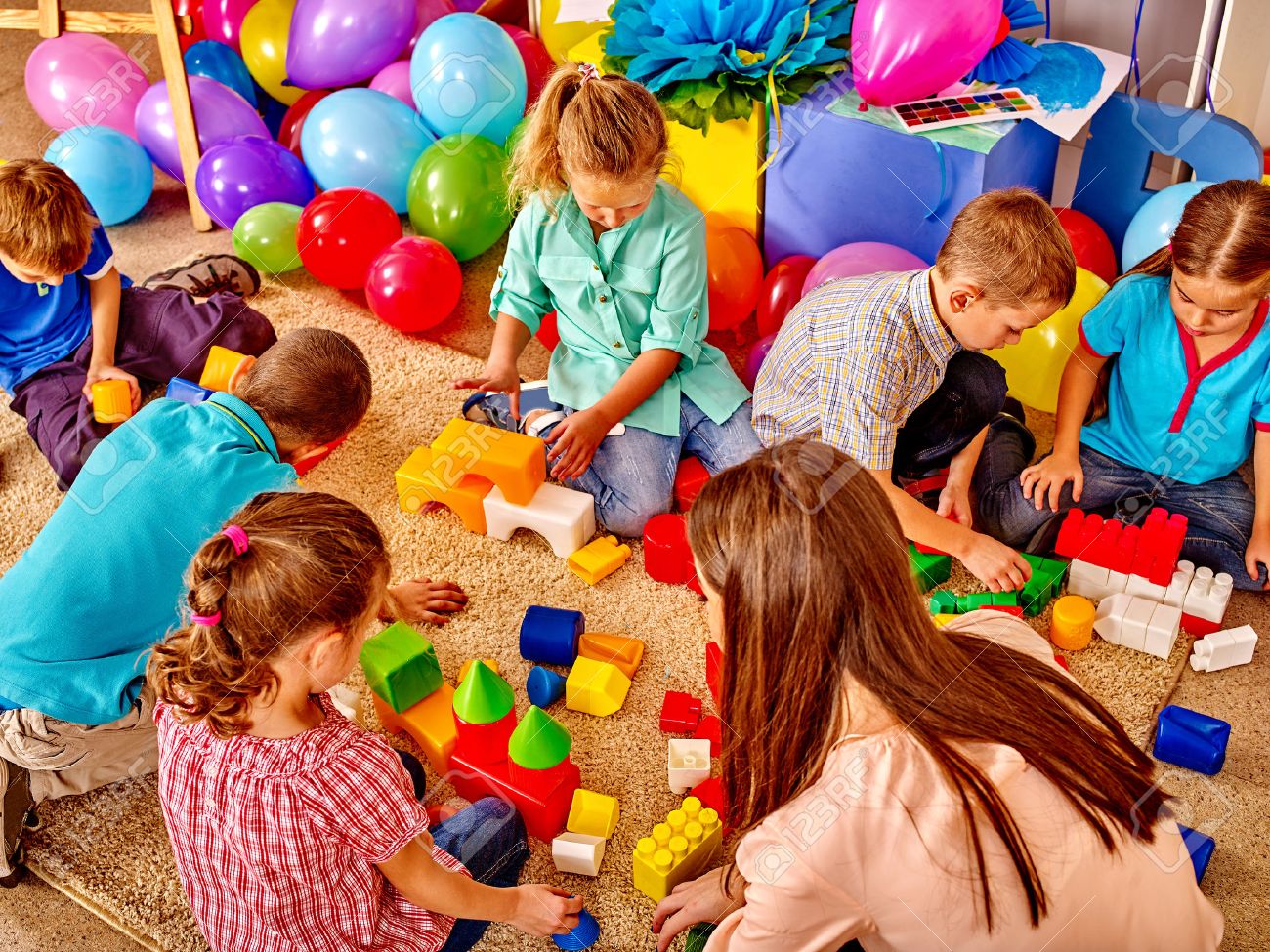 Group children game blocks and balloons on floor in kindergarten . Top view. - 48495034 Group children game blocks and balloons on floor in kindergarten . Top view. - 48495034