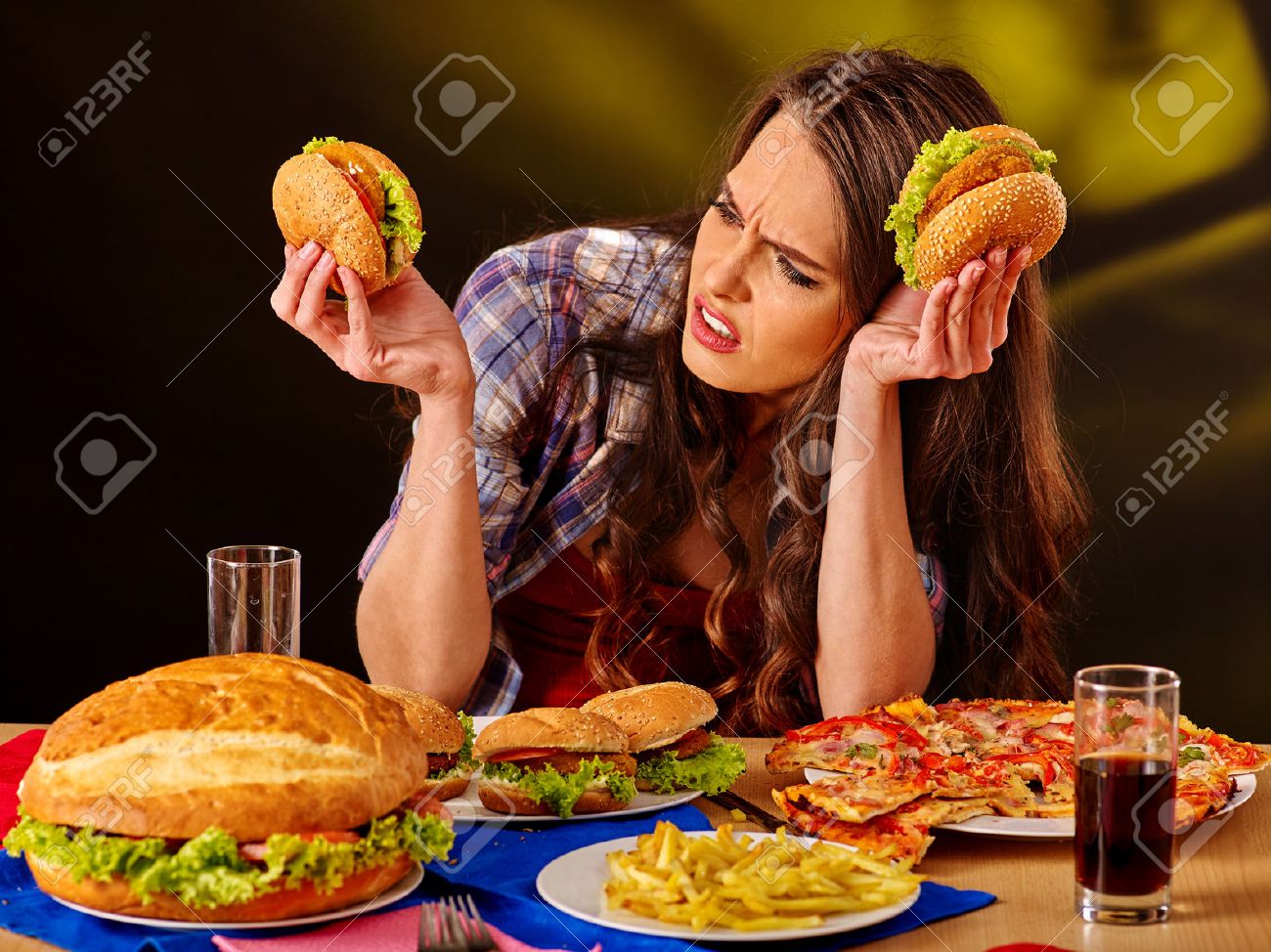 Unhappy girl eat cheap fastfood big hamburger and pizza . - 52232357 Unhappy girl eat cheap fastfood big hamburger and pizza . - 52232357