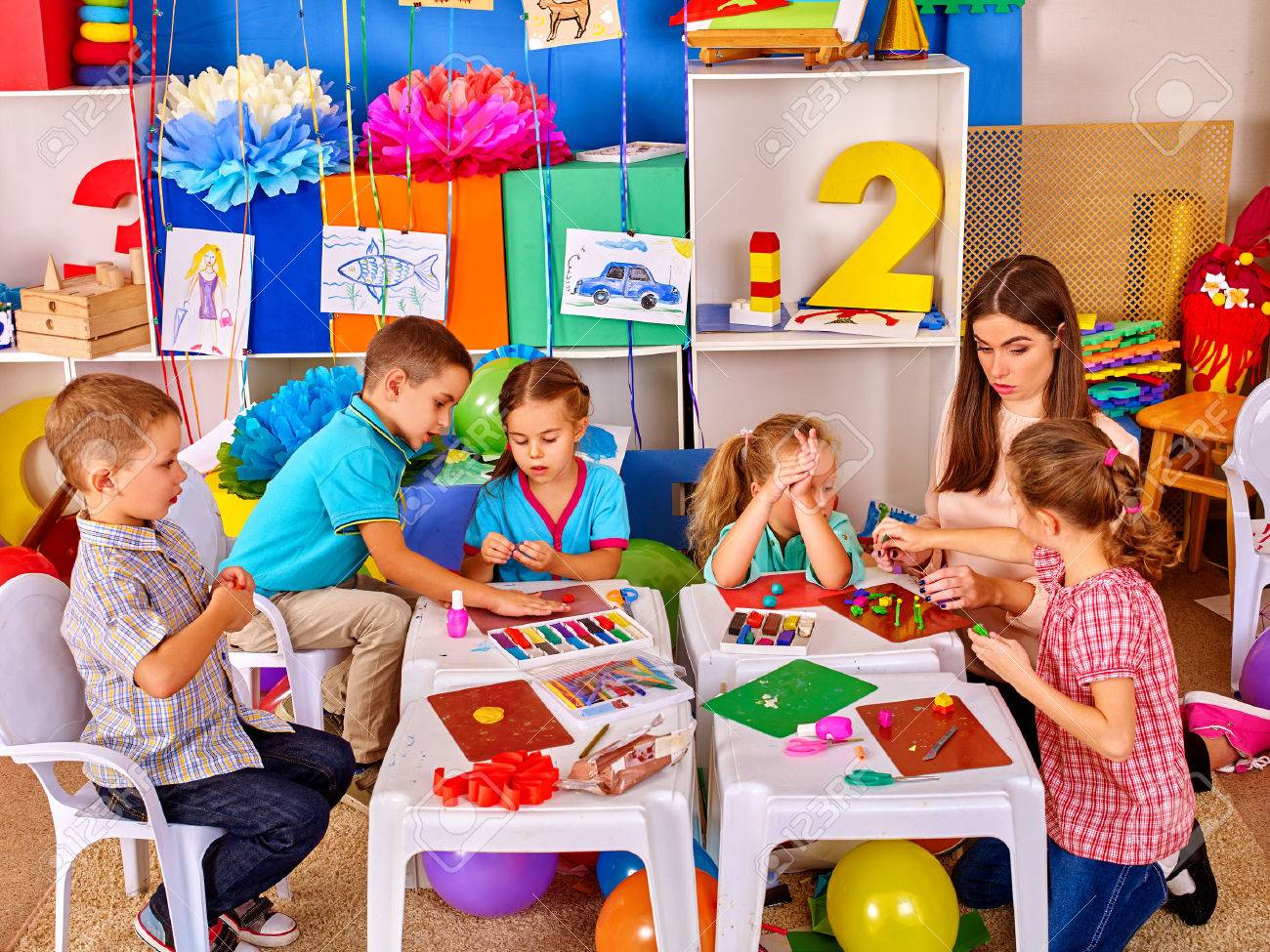 Group clever children with young beautiful teacher mold from plasticine in primary school. Children school education. - 61556738 Group clever children with young beautiful teacher mold from plasticine in primary school. Children school education. - 61556738