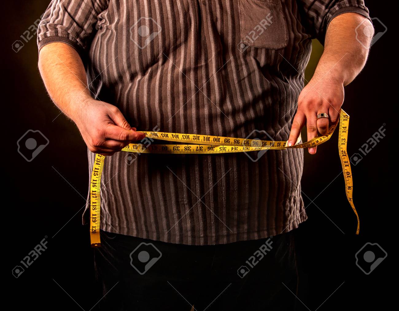 man belly fat with tape measure weight loss around body on black measure for weight loss