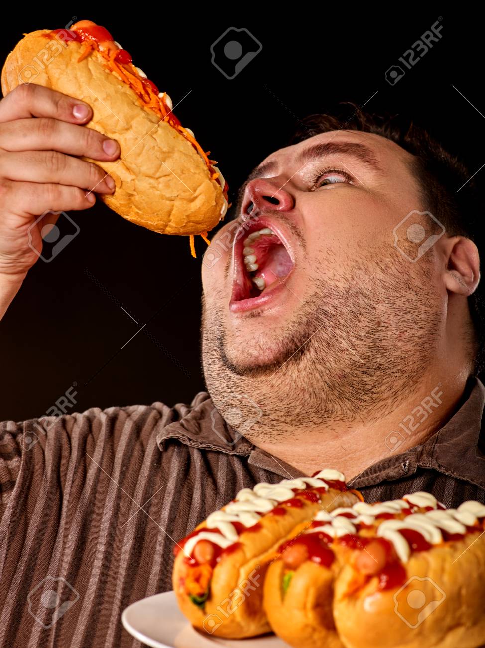 87167801-diet-failure-of-fat-man-eating-fast-food-hot-dog-on-plate-breakfast-for-overweight-person-who-greedi.jpg