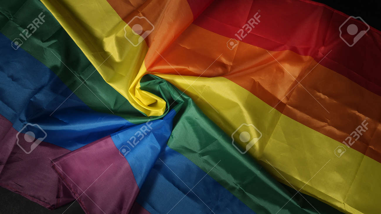LGBTQ pride flag. Lesbian Gay Bi sexsual Transgender Queer. Homosexsual pride Rainbow flag in hand. black background. Represent symbol of freedom, peace, equality and love. LGBTQ concept. - 169136552 LGBTQ pride flag. Lesbian Gay Bi sexsual Transgender Queer. Homosexsual pride Rainbow flag in hand. black background. Represent symbol of freedom, peace, equality and love. LGBTQ concept. - 169136552