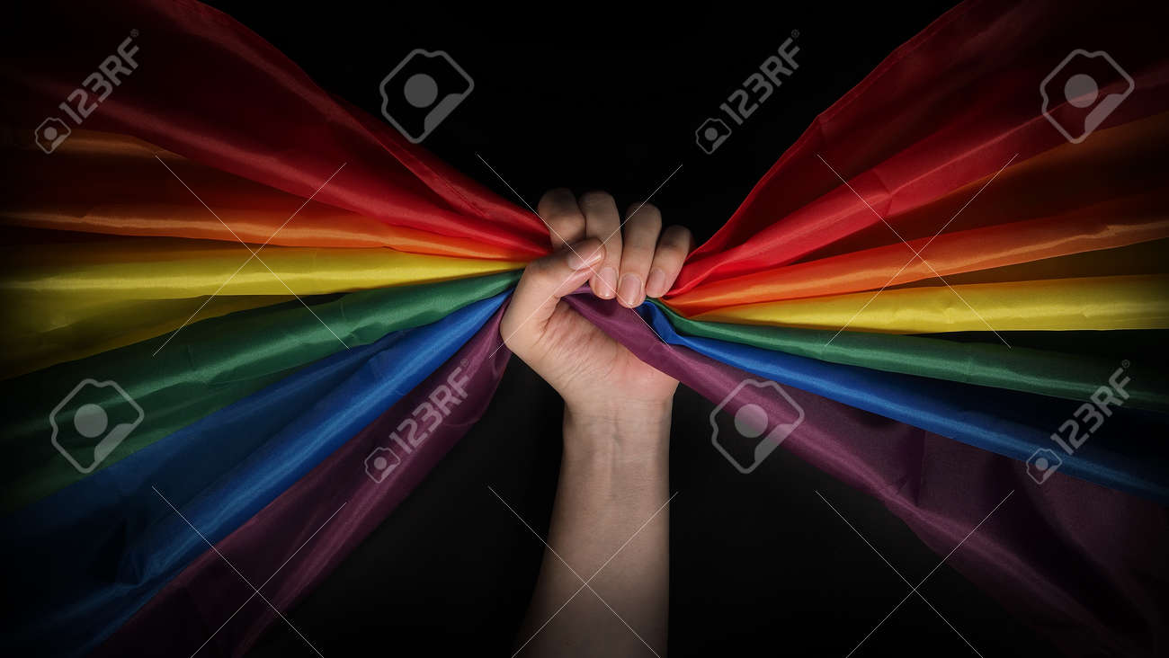 LGBTQ pride flag. Lesbian Gay Bi sexsual Transgender Queer. Homosexsual pride Rainbow flag in hand. black background. Represent symbol of freedom, peace, equality and love. LGBTQ concept. - 169136554 LGBTQ pride flag. Lesbian Gay Bi sexsual Transgender Queer. Homosexsual pride Rainbow flag in hand. black background. Represent symbol of freedom, peace, equality and love. LGBTQ concept. - 169136554