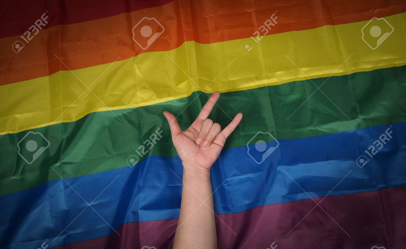 LGBTQ pride flag. Lesbian Gay Bi sexsual Transgender Queer. Homosexsual pride Rainbow flag in hand. black background. Represent symbol of freedom, peace, equality and love. LGBTQ concept. - 169136562 LGBTQ pride flag. Lesbian Gay Bi sexsual Transgender Queer. Homosexsual pride Rainbow flag in hand. black background. Represent symbol of freedom, peace, equality and love. LGBTQ concept. - 169136562